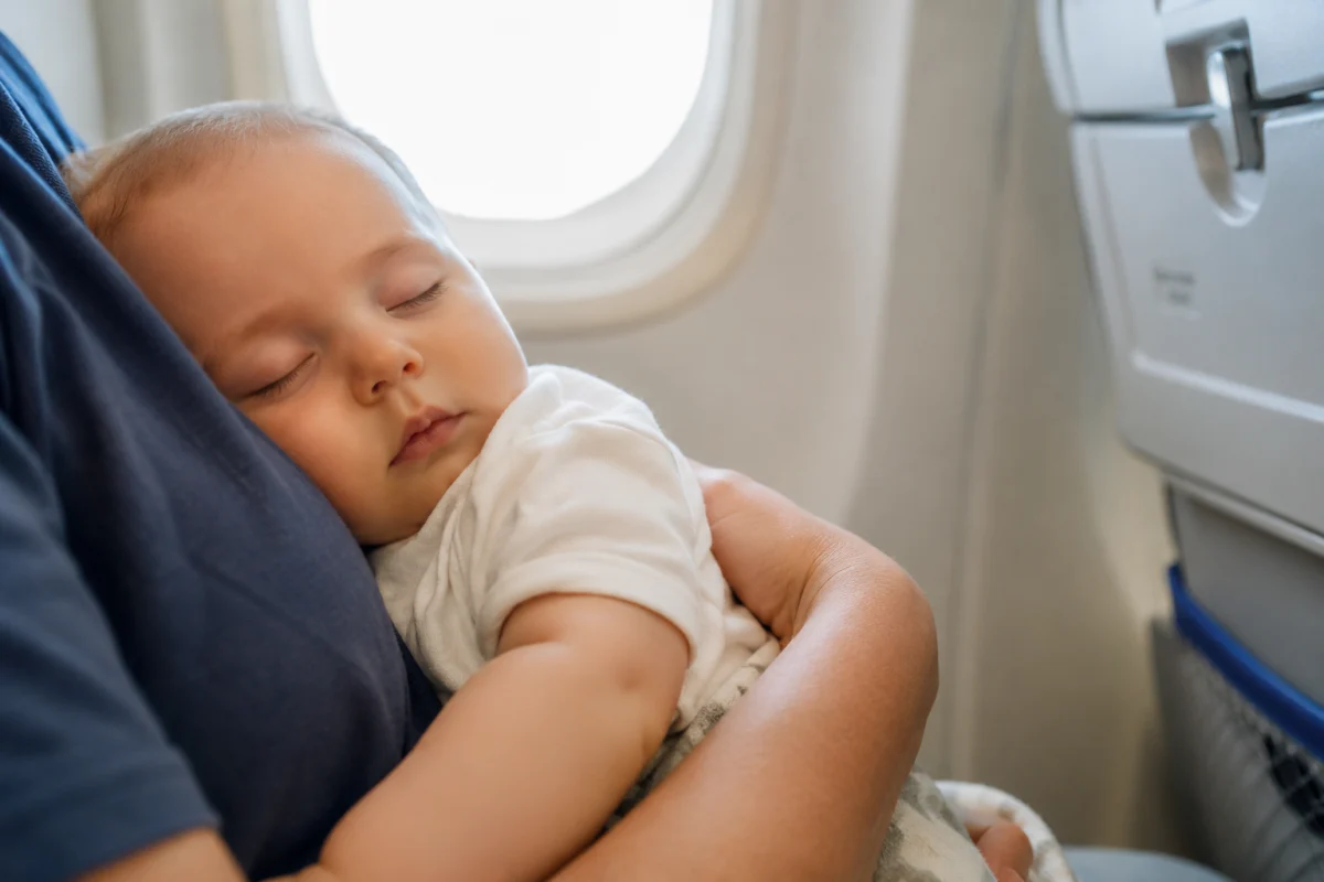 Partir à Bali avec un bébé de 4 mois : ce que j'aurais voulu savoir Sac à langer ouvert avec couches, crème solaire et thermomètre posés sur un lit d'hôtel à Bali
